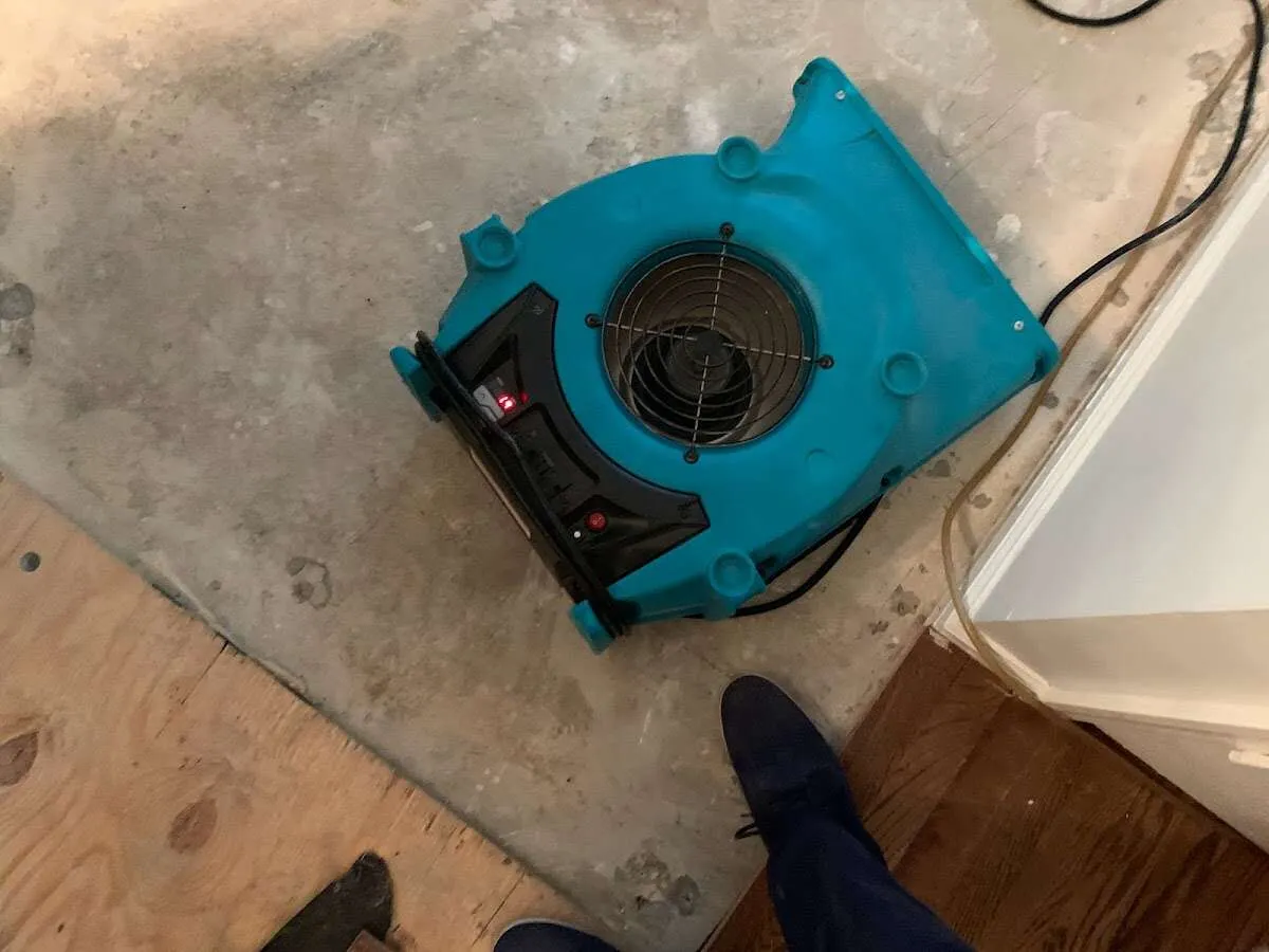 Air mover drying subfloor during Commercial Water Damage Restoration in Leavenworth